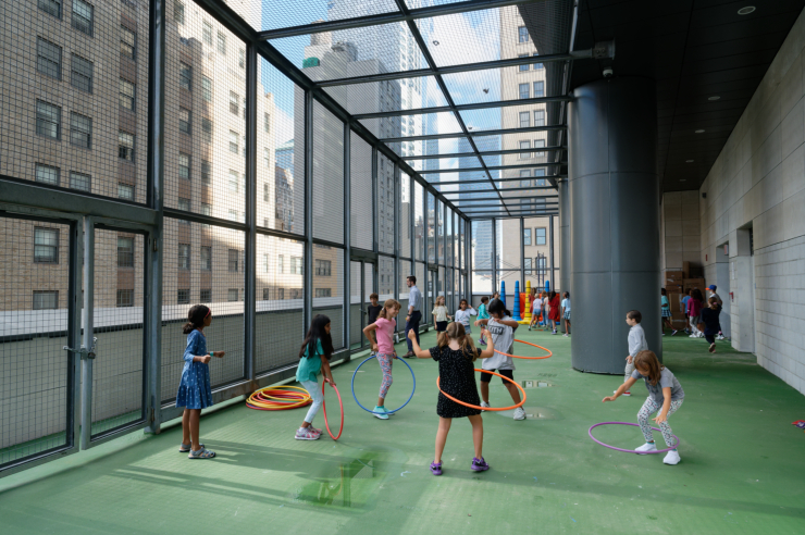 Top: The combination gym and auditorium. At the back of the stage is a barre and mirror for ballet practice. Above: One of the two outdoor play spaces, this one used by the older grades. Photos: Carl Glassman/Tribeca Trib